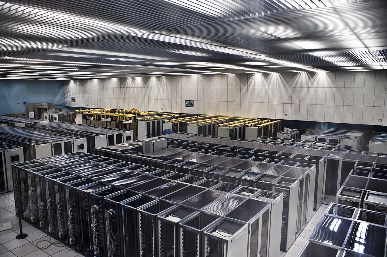 An aisle between densely packed server racks in the CERN data center.