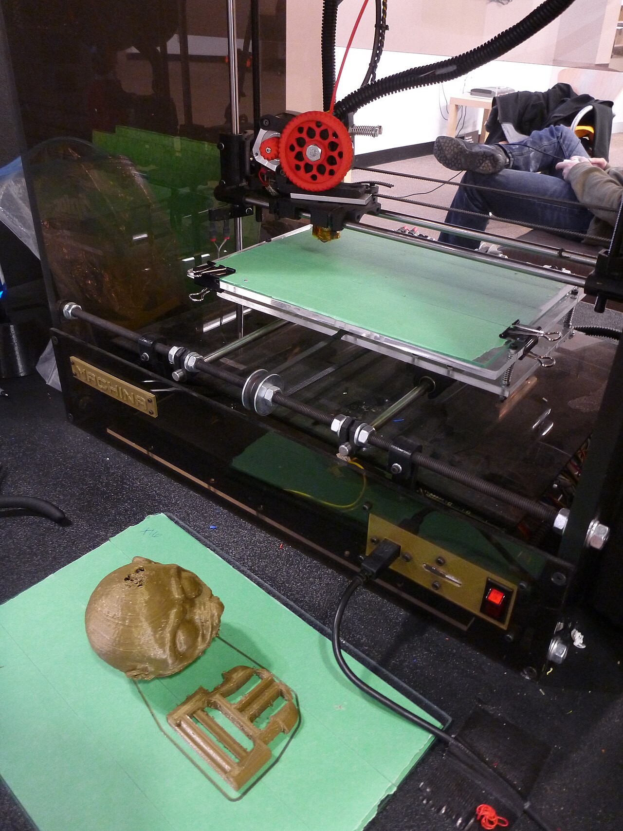 A desktop 3D printer with its build platform and mechanical frame visible