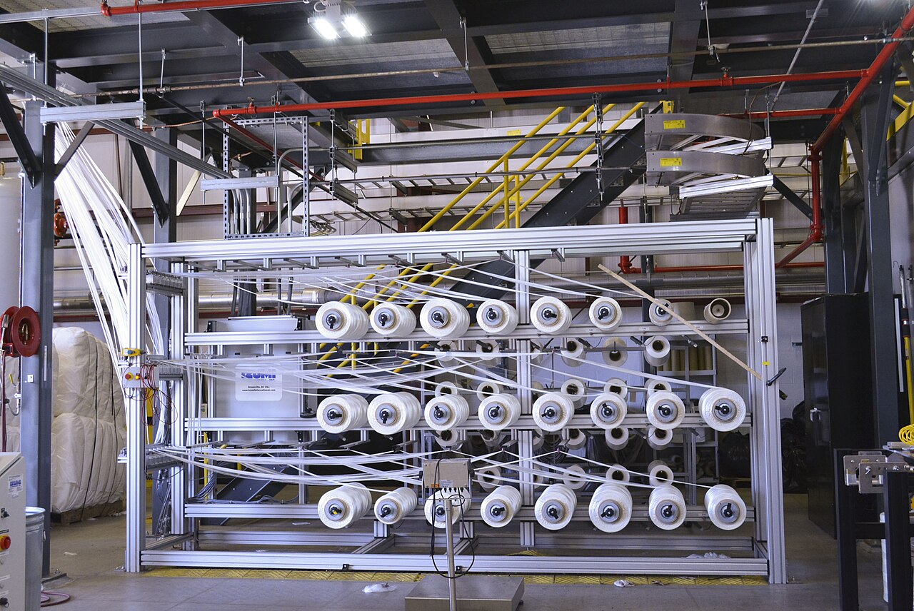 Spools of carbon fiber at the beginning of a production line