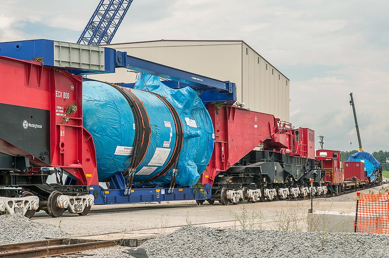 A large reactor vessel transported on a specialized heavy-load rail car