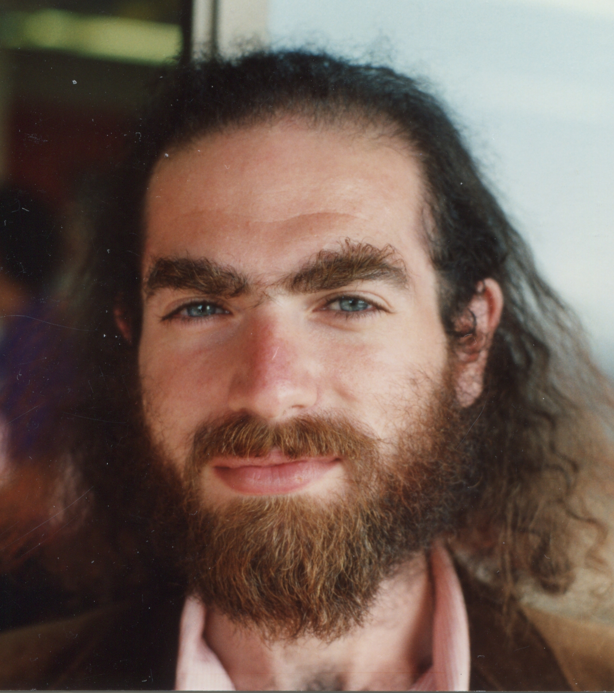 A 1993 portrait photograph of Grigori Perelman at Berkeley, with long hair and a beard.