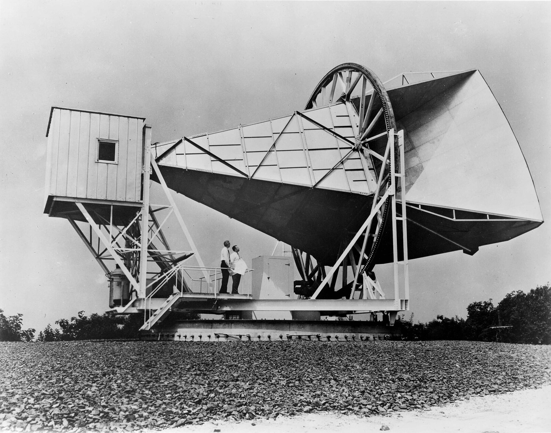 An archival black-and-white photograph of the large horn antenna at Holmdel, New Jersey.