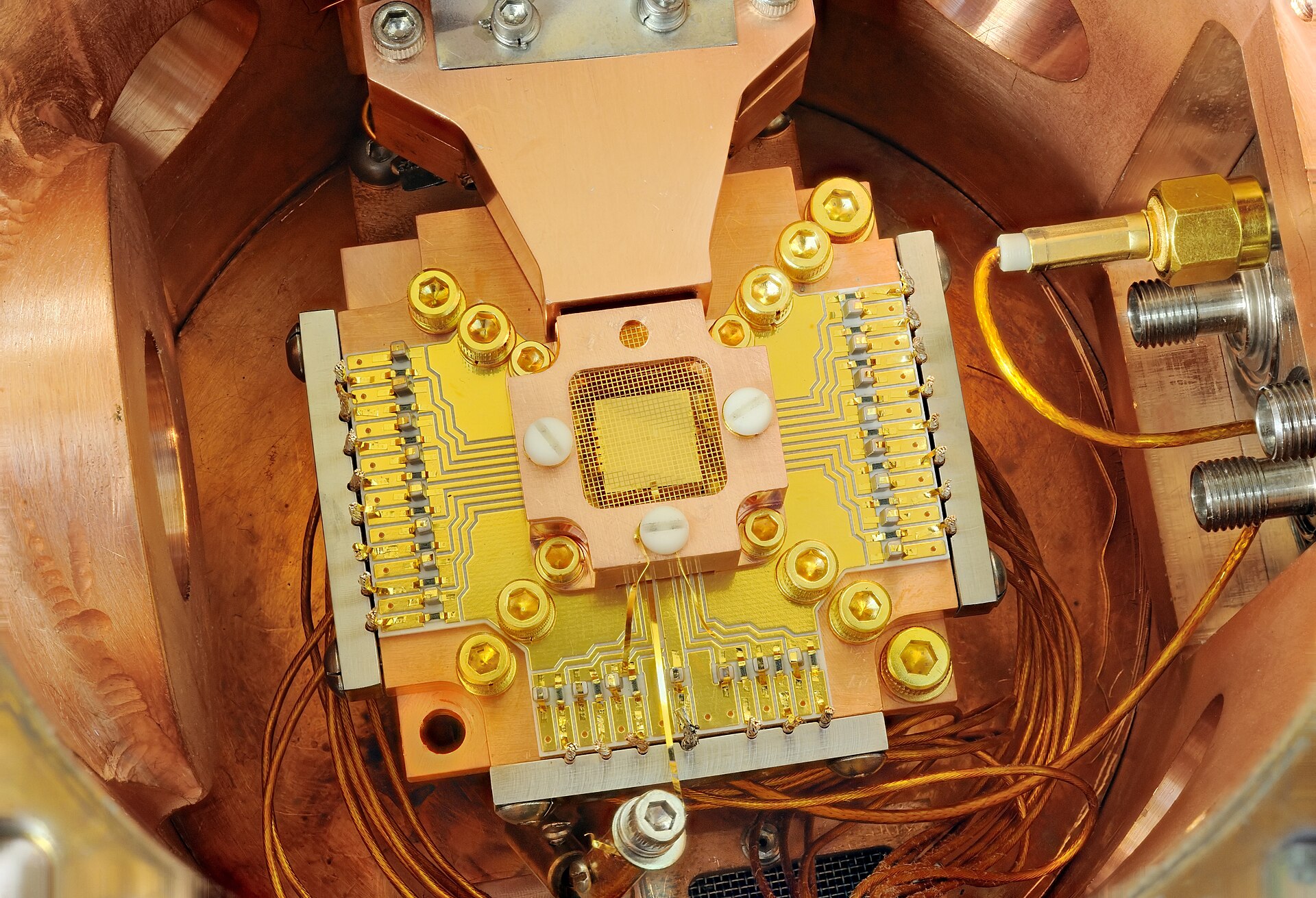 A small ion-trap device and its electrical connections used in NIST quantum-computing research.